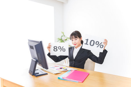 Young businesswoman working at office and holding a sheet of paper