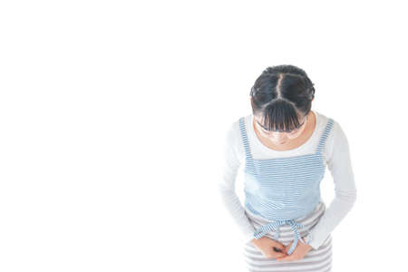 Young woman suffering from backache. Isolated on white background.の写真素材