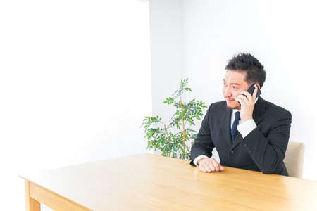 Businessman telephoning at officeの写真素材