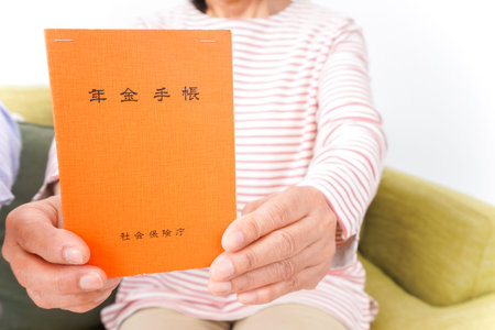 Closeup of a senior woman reading a book while sitting on a sofa