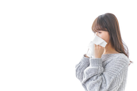 Woman blowing her noseの写真素材