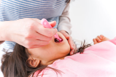 Close up of a woman having her teeth brushed by a beauticianの写真素材