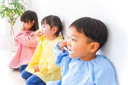 Children playing in the living room at homeの写真素材