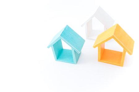 Wooden toy house isolated on white background. Real estate concept.