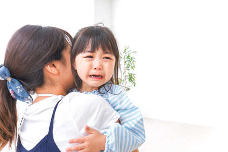 Crying child and motherの写真素材