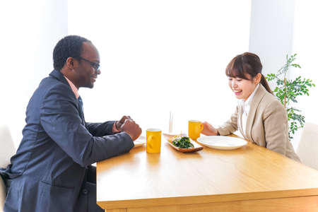 Businesspersons having lunch at cafeの写真素材
