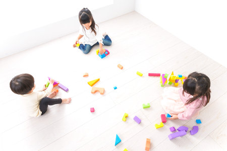 Children playing in the room, shot from the top view on a white background