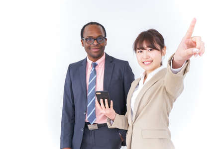 Businesspersons searching location by smartphoneの写真素材