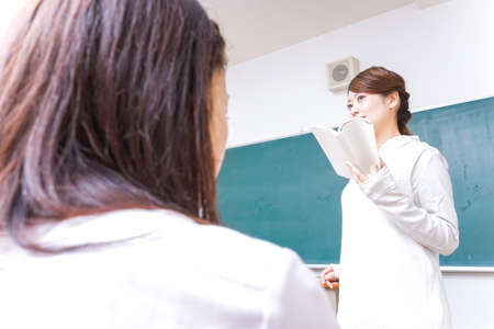 Female teacher having books giving lessonsの写真素材
