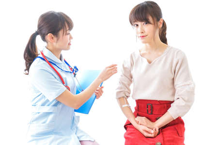 Nurse putting woman on a dripの写真素材