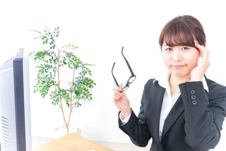 business woman suffering from dry eyeの写真素材