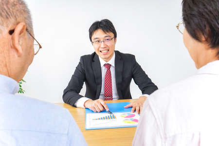 Aged couple and businessmanの写真素材