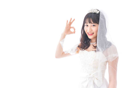 A shot of a beautiful asian bride making OK sign high quality photoの写真素材