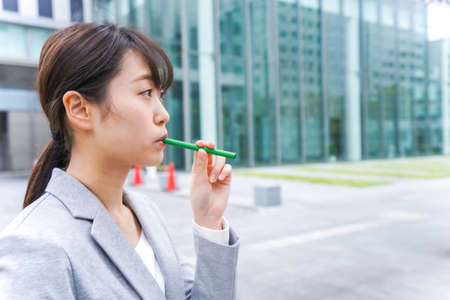 Businesswoman blowing a whistle in the cityの写真素材