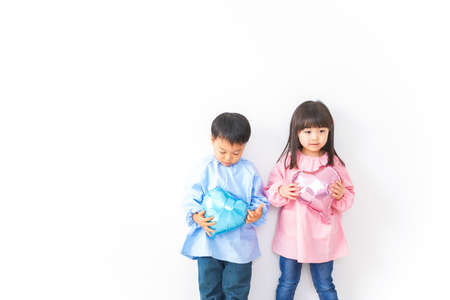 Children holding a heart-shaped object in their handsの写真素材