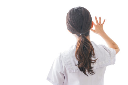 Young woman wearing a white coat (back side view)