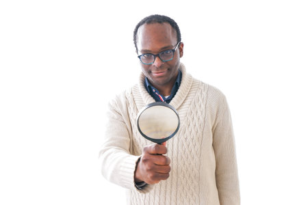 Man looking at something through a magnifying glass