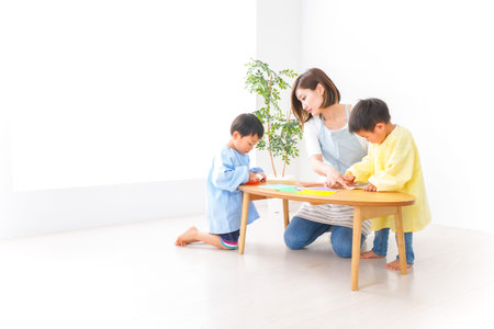 Childhood and family care concept - Young asian family playing together at homeの写真素材