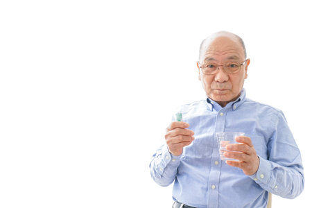 Aged man taking a pill