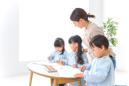 Children and teacher at Kindergarten, education and learning concept.