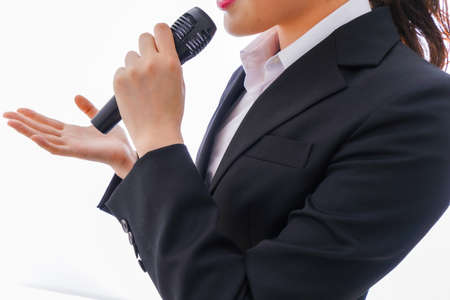 Businesswoman with microphone on white background, closeup.の写真素材