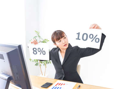 Businesswoman showing a percentage sign taken in the office, shot in the studioの写真素材
