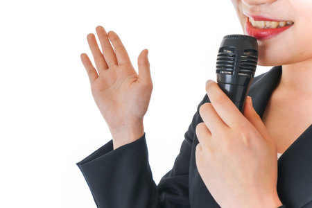 Close-up of woman singing with microphone, isolated on white background