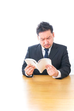 Businessperson reading bookの写真素材
