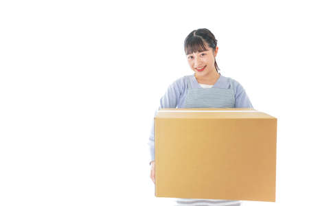 Young asian woman holding a cardboard box isolated on white background.の写真素材
