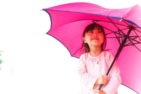 A child opening an umbrellaの写真素材