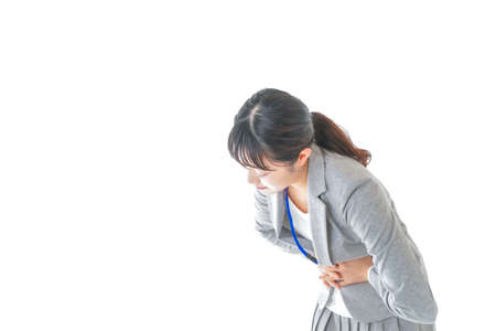 Woman suffering from backache after exercising. Health care and medical concept.の写真素材