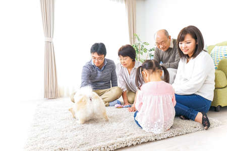 Family playing with dogの写真素材