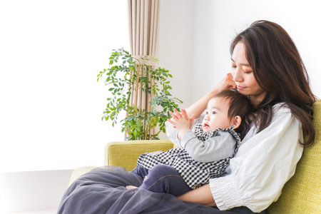Mother and baby in the living room at home, happy family concept