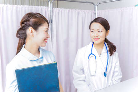 female doctor and nurse doing a meetingの写真素材
