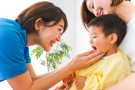 Asian mother and daughter playing with their son at home. Happy family concept.