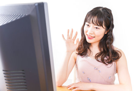 Young woman at home using video chatの写真素材