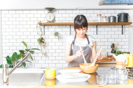 Cooking young womanの写真素材