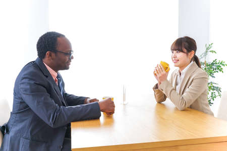 Businesspeople having lunch at cafeの写真素材