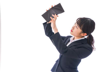 Young business woman holding a briefcase shot in the studio on a white backgroundの写真素材