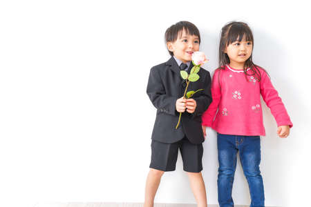 Girl and boy with a bouquet of flowers.
