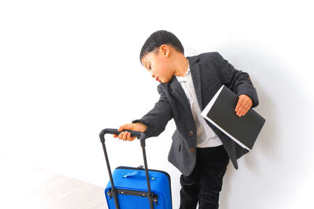 Young Asian business man with luggage on white background, travel concept.の写真素材