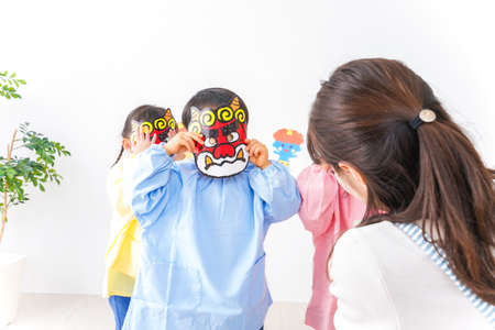 Children playing with a mask in the living room, high quality photoの写真素材