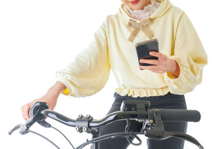 Woman with bicycle and mobile phone isolated on white background. Close-up.の写真素材
