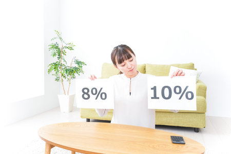 Young woman at home with 40 percent off price sign taken in 2014