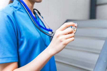 Close up of female doctor holding stethoscope in her hand.