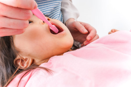 Close-up of a little girl's face being examined