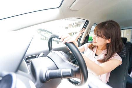 Woman driver waving her handsの写真素材