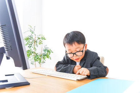 Child businessman working at office