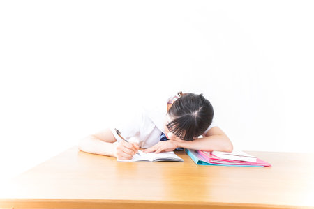 Schoolgirl studying at the desk image with white background, Education concept.