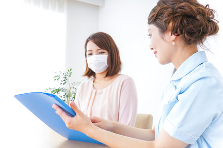 women listening to explanation at hospitalの写真素材